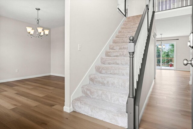 1312 Wicklow Dr, Bloomington, IL 61705 - stairs with a chandelier and wood finished floors