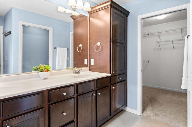 1312 Wicklow Dr, Bloomington, IL 61705 - full bath with double vanity, a chandelier, tile patterned flooring, and a spacious closet