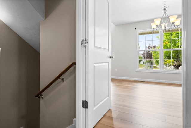 1312 Wicklow Dr, Bloomington, IL 61705 - stairs featuring a chandelier and wood finished floors