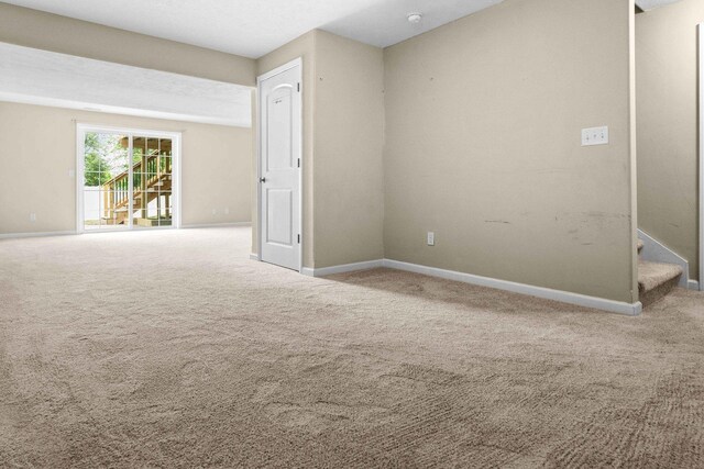 1312 Wicklow Dr, Bloomington, IL 61705 - spare room featuring carpet, stairs, and a smoke detector