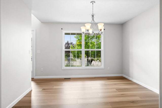 1312 Wicklow Dr, Bloomington, IL 61705 - unfurnished dining area with a chandelier and wood finished floors