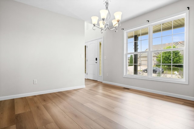 1312 Wicklow Dr, Bloomington, IL 61705 - unfurnished room featuring a chandelier and light wood-style flooring