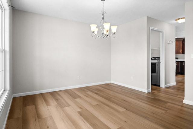 1312 Wicklow Dr, Bloomington, IL 61705 - empty room with a chandelier, light wood-style floors, and washer / clothes dryer
