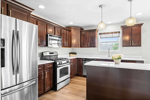 1312 Wicklow Dr, Bloomington, IL 61705 - kitchen with stainless steel appliances, light countertops, light wood finished floors, and recessed lighting
