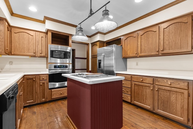 4113 Eaton Dr, Rockford, IL 61114 - kitchen featuring appliances with stainless steel finishes, ornamental molding, hardwood / wood-style floors, a kitchen island, and light countertops