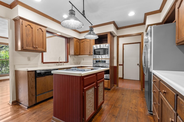 4113 Eaton Dr, Rockford, IL 61114 - kitchen with stainless steel appliances, dark wood finished floors, light countertops, a kitchen island, and crown molding