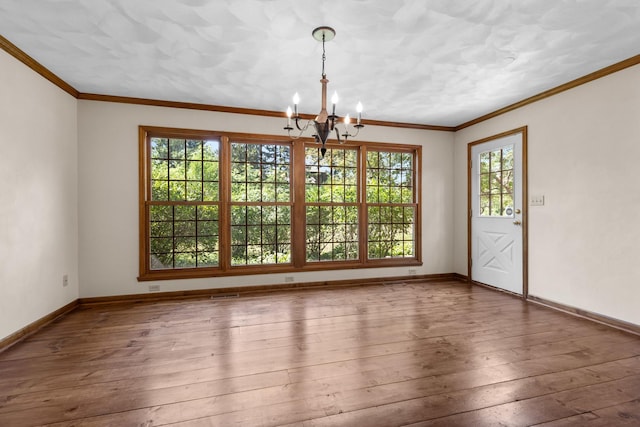 4113 Eaton Dr, Rockford, IL 61114 - unfurnished dining area with a chandelier, wood-type flooring, and ornamental molding