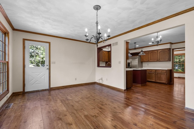 4113 Eaton Dr, Rockford, IL 61114 - kitchen featuring a chandelier, light countertops, dark wood finished floors, and ornamental molding