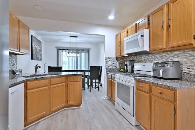 654 Kingsbridge Dr, Carol Stream, IL 60188 - kitchen featuring white appliances, a peninsula, light wood-type flooring, and decorative backsplash