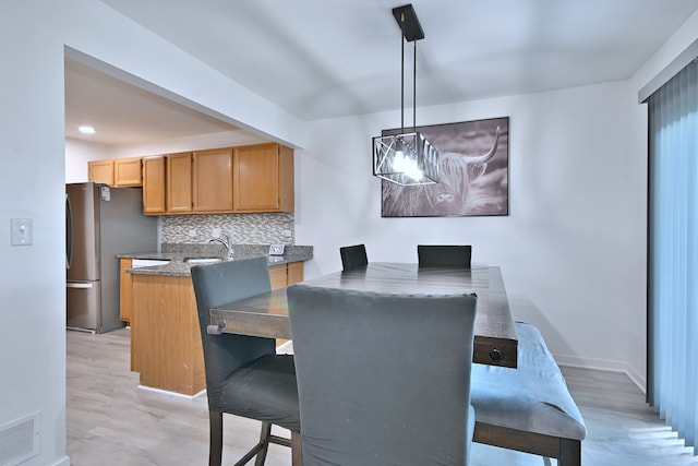 654 Kingsbridge Dr, Carol Stream, IL 60188 - dining space featuring a chandelier and light wood-style flooring
