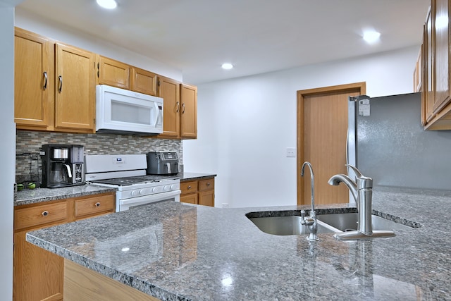 654 Kingsbridge Dr, Carol Stream, IL 60188 - kitchen featuring white appliances, tasteful backsplash, dark stone counters, and recessed lighting