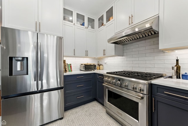 5729 S Harper Ave, Chicago, IL 60637 - kitchen featuring stainless steel appliances, under cabinet range hood, light countertops, white cabinets, and backsplash