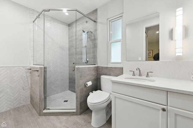 5729 S Harper Ave, Chicago, IL 60637 - bathroom featuring vanity, a stall shower, tile walls, and wood finished floors