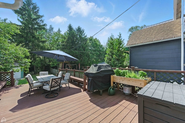 5729 S Harper Ave, Chicago, IL 60637 - deck with outdoor dining space, a storage shed, and a grill