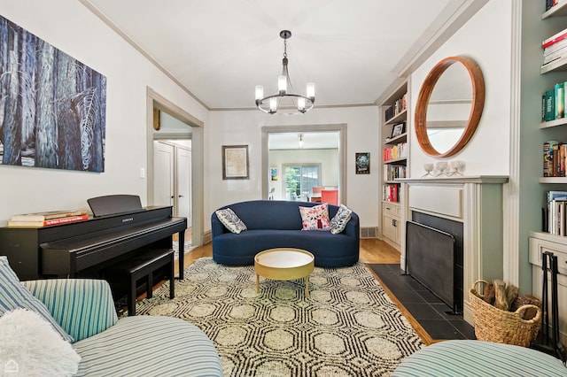 5729 S Harper Ave, Chicago, IL 60637 - living room featuring a tile fireplace, a chandelier, wood finished floors, and crown molding