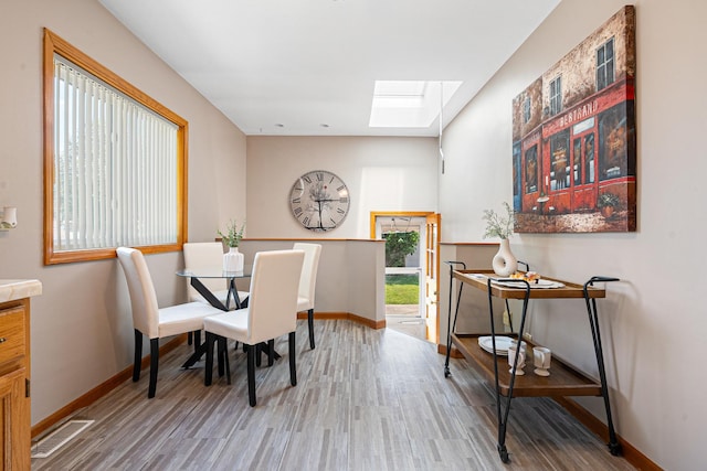 5401 S Nagle Ave, Chicago, IL 60638 - dining room featuring a skylight and wood finished floors