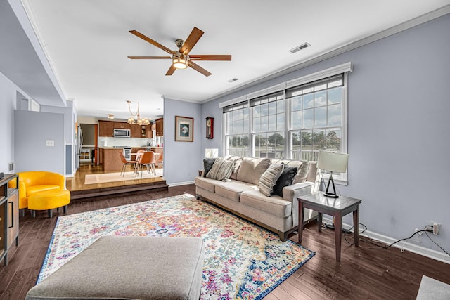 26711 S Greenbriar Dr, Monee, IL 60449 - living room featuring ceiling fan, ornamental molding, a chandelier, and dark wood-type flooring