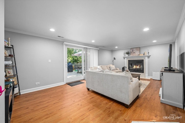 447 Newport Dr, Naperville, IL 60565 - living room with ornamental molding, recessed lighting, light wood-style flooring, and a glass covered fireplace