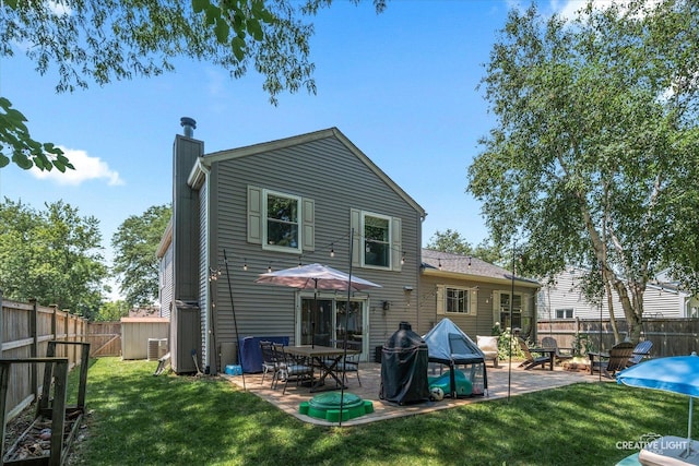 447 Newport Dr, Naperville, IL 60565 - back of property with a chimney, a patio, and a fenced backyard