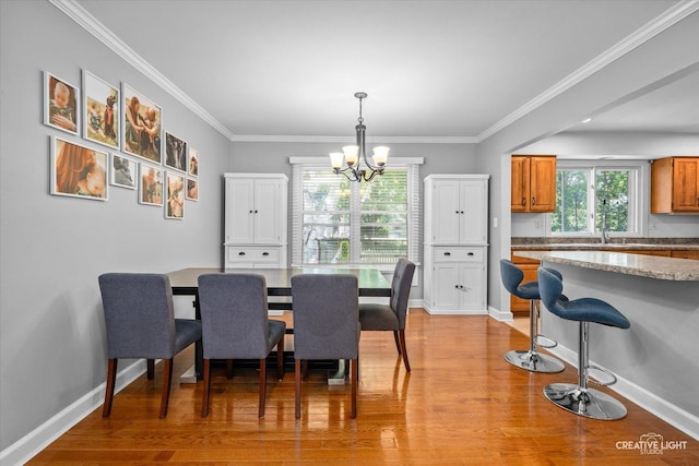 447 Newport Dr, Naperville, IL 60565 - dining room featuring a chandelier, light wood-style floors, and ornamental molding