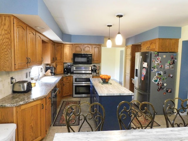565 Sandra Cir, Freeport, IL 61032 - kitchen with appliances with stainless steel finishes, a kitchen island, tasteful backsplash, brown cabinetry, and hanging light fixtures