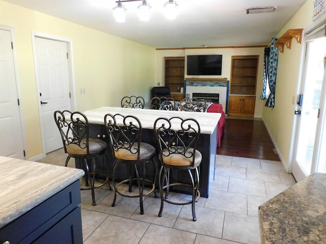 565 Sandra Cir, Freeport, IL 61032 - dining room featuring plenty of natural light, light tile patterned flooring, and a fireplace