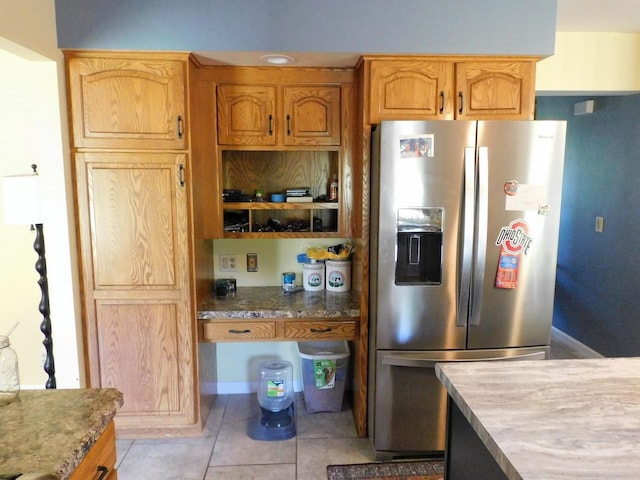 565 Sandra Cir, Freeport, IL 61032 - kitchen with stainless steel refrigerator with ice dispenser, light tile patterned flooring, and stone countertops