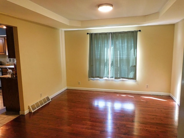 565 Sandra Cir, Freeport, IL 61032 - spare room with wood finished floors and a raised ceiling
