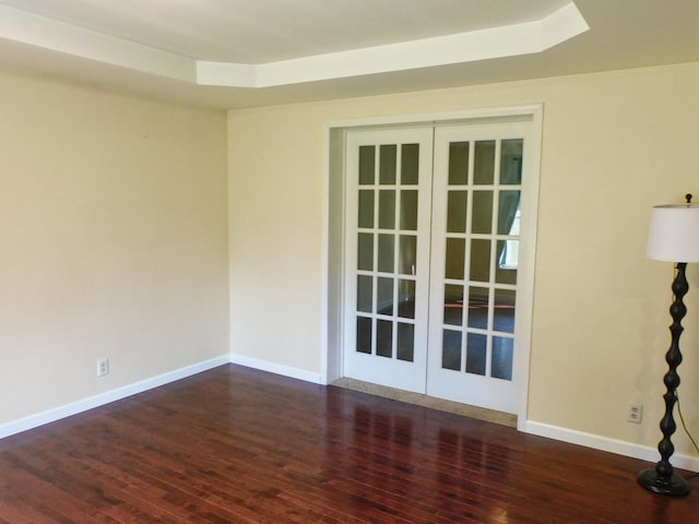 565 Sandra Cir, Freeport, IL 61032 - spare room with french doors, wood finished floors, and a tray ceiling