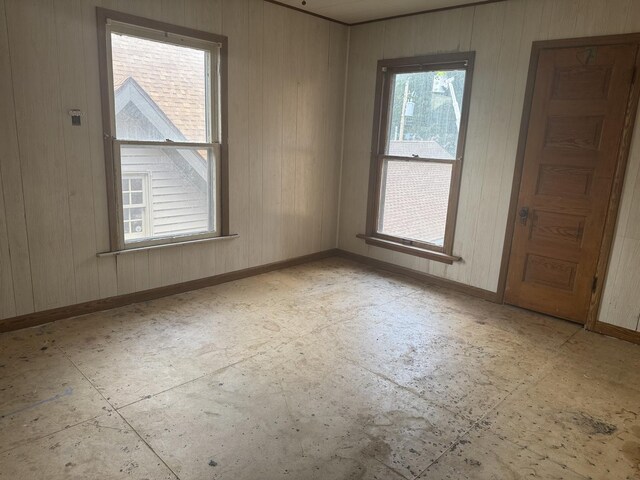 614 N Jackson St, Clinton, IL 61727 - unfurnished room featuring baseboards and wooden walls