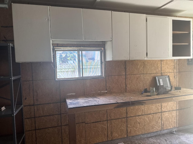 614 N Jackson St, Clinton, IL 61727 - kitchen with white cabinets, tasteful backsplash, and open shelves