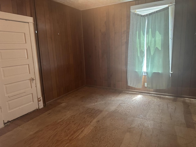 614 N Jackson St, Clinton, IL 61727 - empty room featuring wood walls and wood finished floors