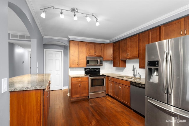 2300 Old Tavern Rd Unit 101, Lisle, IL 60532 - kitchen with appliances with stainless steel finishes, arched walkways, crown molding, light stone counters, and tasteful backsplash