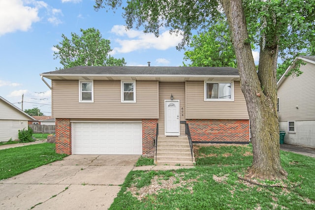 609 W Romeo Rd, Romeoville, IL 60446 - split foyer home featuring brick siding, driveway, an attached garage, and a front lawn