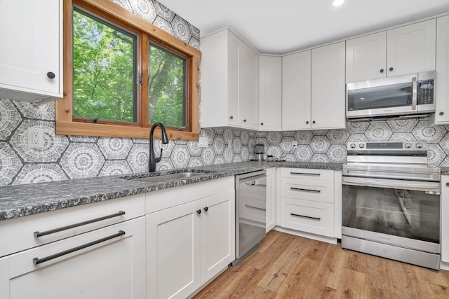 746 Old Stage Rd, Morris, IL 60450 - kitchen with appliances with stainless steel finishes, white cabinetry, decorative backsplash, and light wood-type flooring