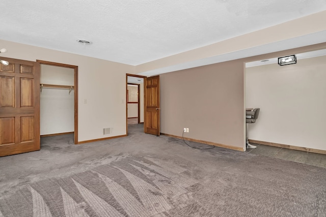 746 Old Stage Rd, Morris, IL 60450 - unfurnished bedroom featuring light carpet, a spacious closet, and a textured ceiling