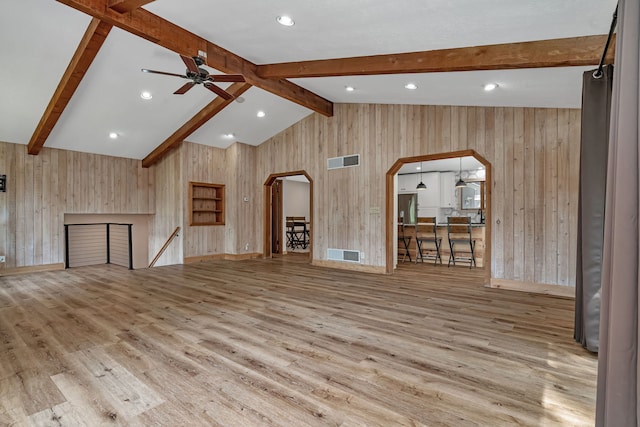 746 Old Stage Rd, Morris, IL 60450 - unfurnished living room with arched walkways, wood walls, wood finished floors, a ceiling fan, and recessed lighting