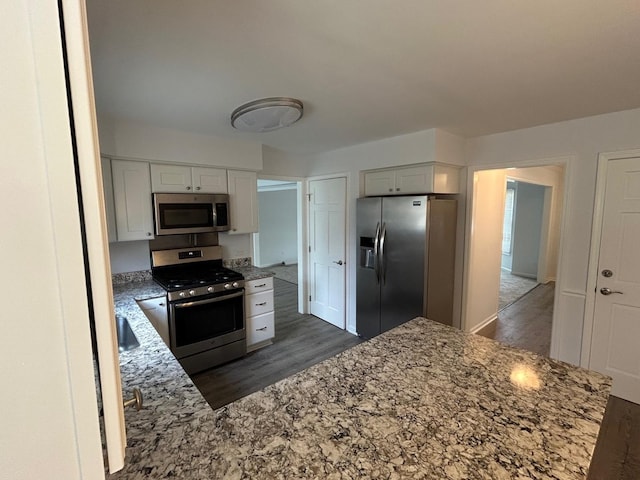 105 Golf View Cir, Prospect Heights, IL 60070 - kitchen with stainless steel appliances, light stone counters, wood finished floors, and white cabinetry