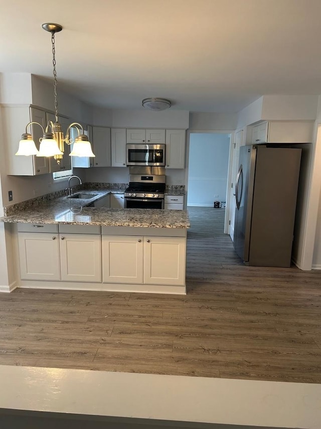 105 Golf View Cir, Prospect Heights, IL 60070 - kitchen featuring stainless steel appliances, dark wood-style flooring, a peninsula, a chandelier, and dark stone counters