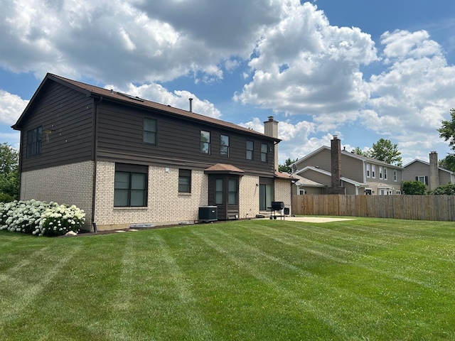 105 Golf View Cir, Prospect Heights, IL 60070 - rear view of house featuring brick siding and a chimney