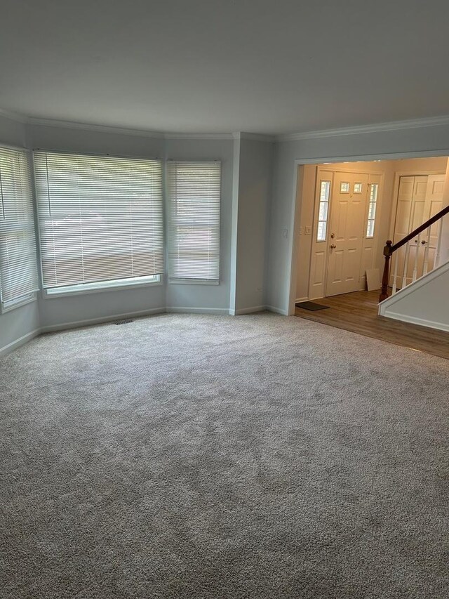 105 Golf View Cir, Prospect Heights, IL 60070 - unfurnished living room with ornamental molding, carpet floors, and stairs
