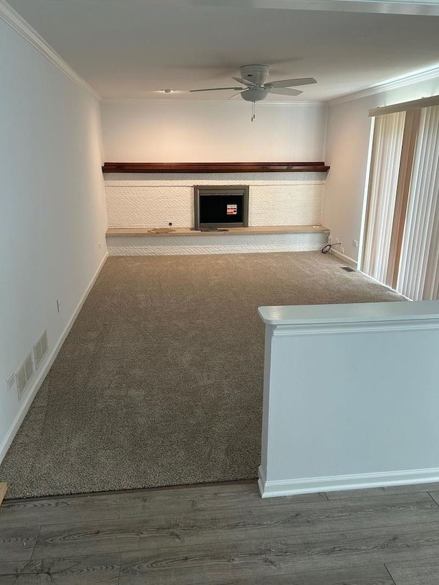 105 Golf View Cir, Prospect Heights, IL 60070 - unfurnished living room with ornamental molding, a ceiling fan, a fireplace, wood finished floors, and carpet floors