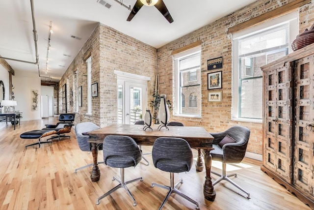 2035 W Charleston St Unit 205, Chicago, IL 60647 - dining area featuring brick wall, wood finished floors, track lighting, plenty of natural light, and a ceiling fan