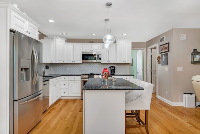2831 E 28th Rd, Marseilles, IL 61341 - kitchen featuring stainless steel appliances, light wood-style floors, a center island, white cabinetry, and recessed lighting