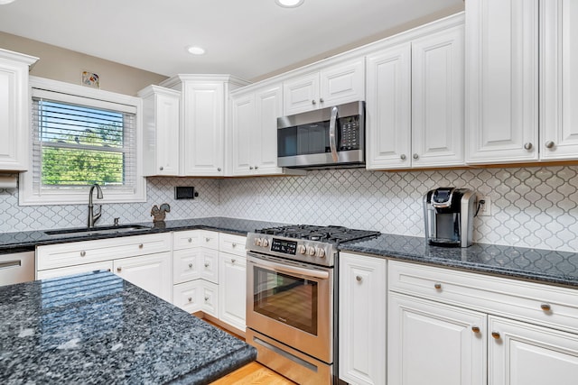 2831 E 28th Rd, Marseilles, IL 61341 - kitchen with appliances with stainless steel finishes, white cabinets, dark stone countertops, backsplash, and recessed lighting