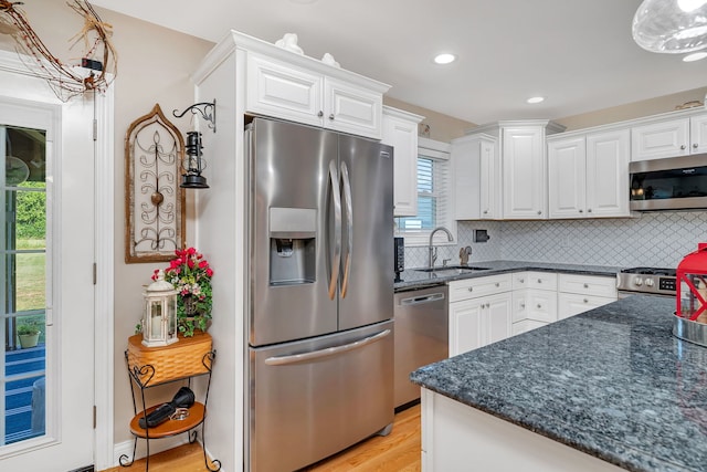 2831 E 28th Rd, Marseilles, IL 61341 - kitchen featuring stainless steel appliances, white cabinets, light wood finished floors, decorative backsplash, and recessed lighting