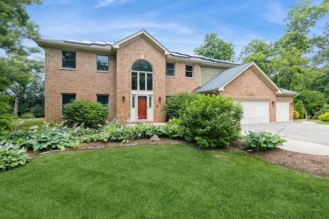 2809 Jenny Jae Ln, Crystal Lake, IL 60012 - view of front of house featuring brick siding, a front yard, concrete driveway, and an attached garage