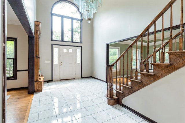 2809 Jenny Jae Ln, Crystal Lake, IL 60012 - entryway with stairs, a towering ceiling, a chandelier, and crown molding