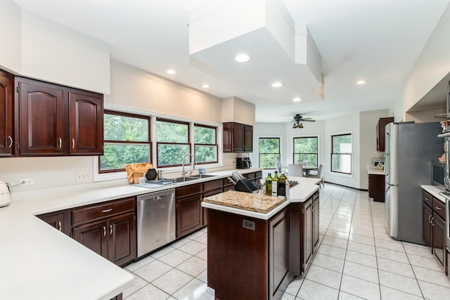 2809 Jenny Jae Ln, Crystal Lake, IL 60012 - kitchen featuring appliances with stainless steel finishes, light countertops, light tile patterned flooring, a kitchen island, and ceiling fan