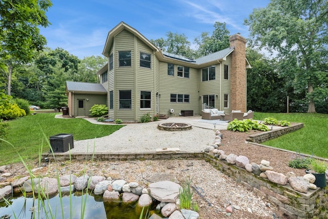 2809 Jenny Jae Ln, Crystal Lake, IL 60012 - rear view of property featuring an outdoor living space with a fire pit, a patio area, a lawn, and a chimney